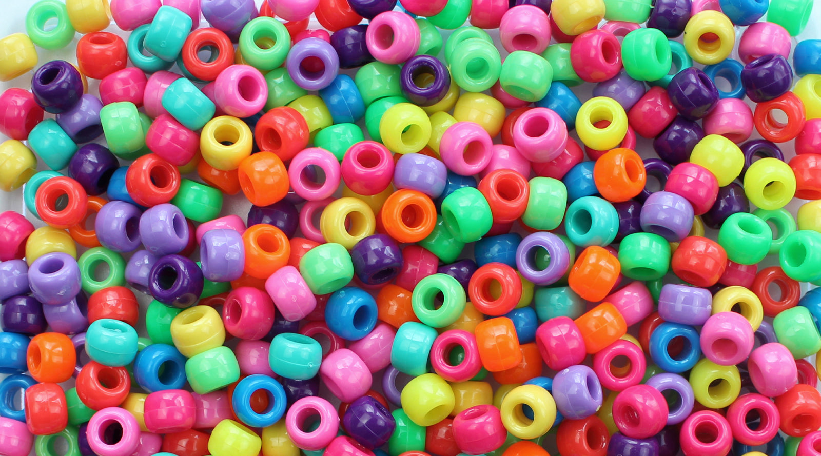 Colorful plastic pony beads in various bright colors.