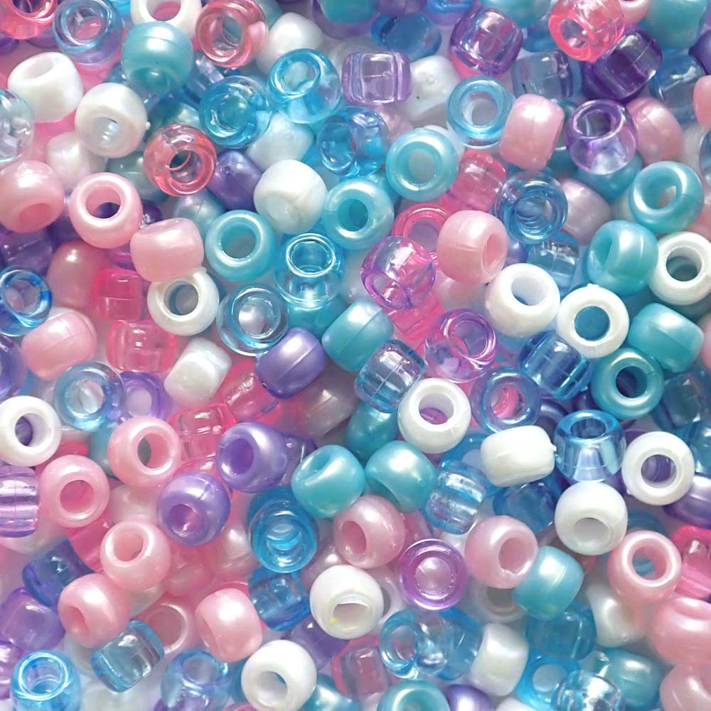 Assorted colorful pony beads in a mix of pink, blue, purple, and white.