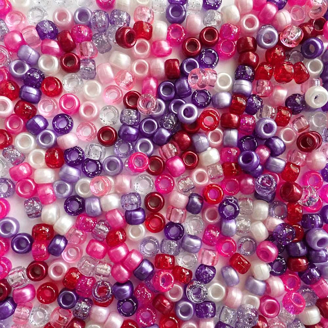Close-up of Valentine's theme multicolored pony beads including pink, purple, and red.