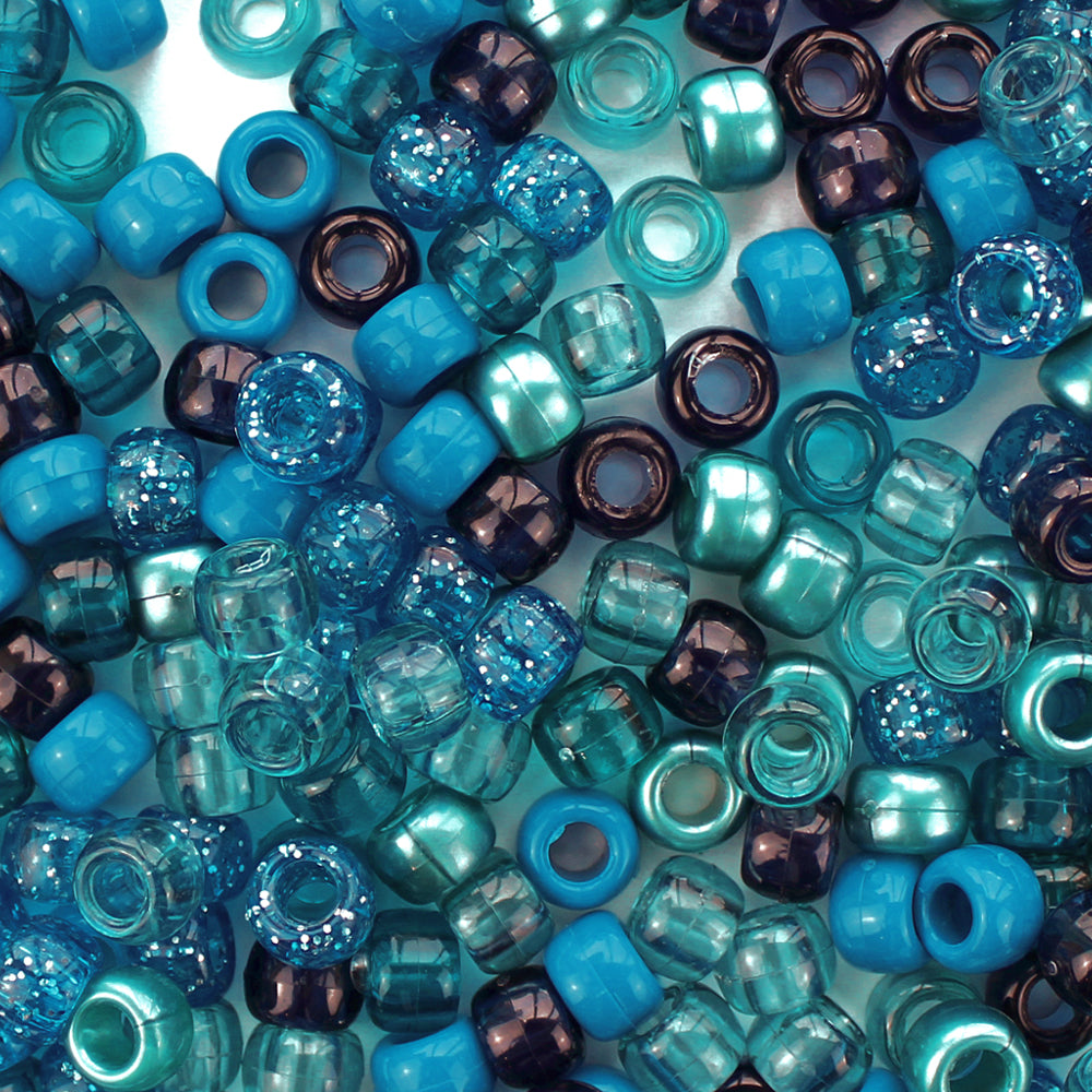 Plastic pony beads in a mix of different shades of blue and turquoise