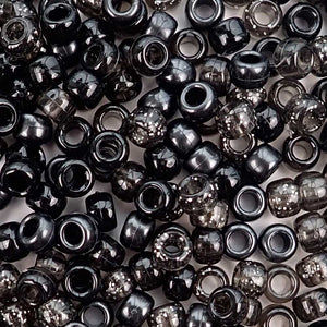 Plastic pony beads in a mix of different shades of black